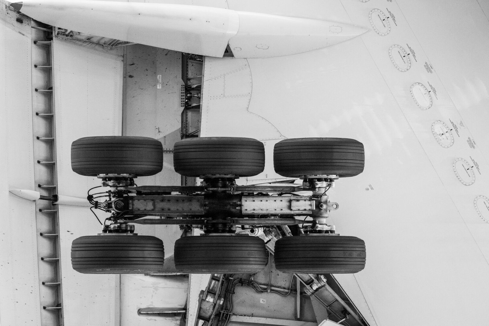 extreme closeup of aircraft undercarriage, from directly below